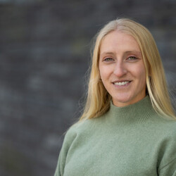 Portrait of Kate Seary wearing light green jumper